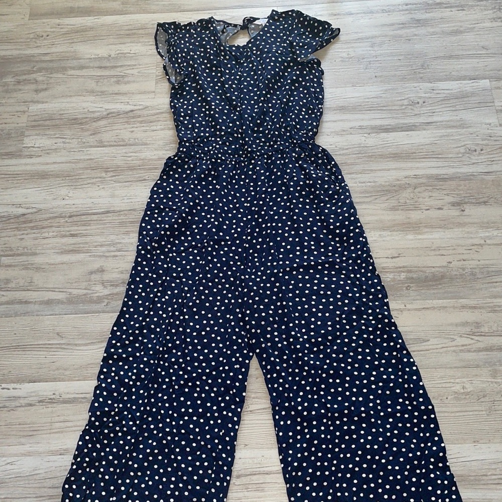 Navy blue jumpsuit with white polka dolts throughout, size medium